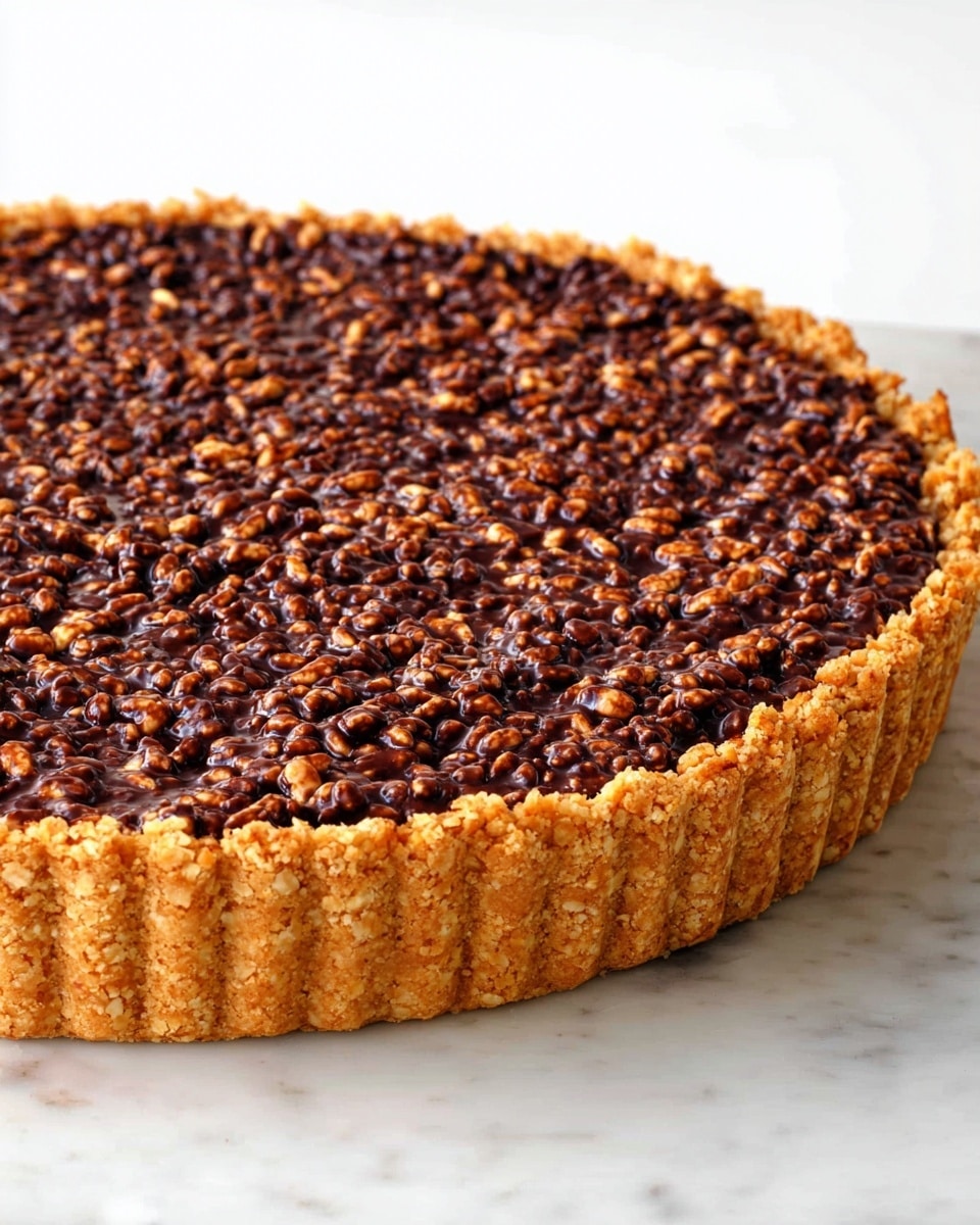 The image shows a tart with three clear layers. The bottom layer is a golden brown crumbly crust that lines the tart pan, thick and textured. The middle layer is a smooth, creamy light brown filling that fills the base evenly. The top layer is dark chocolate mixed with small crunchy bits, covering the filling fully with a rough, bumpy texture. A piece of the tart is lifted above the rest by a metal spatula, showing a clean slice with all layers visible. The tart sits on a flat surface with a white marbled texture, and the background is plain white. photo taken with an iphone --ar 4:5 --v 7