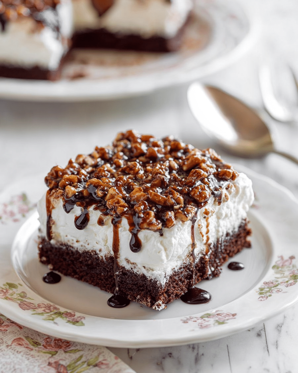 A square piece of chocolate cake sits on a white plate with a floral design. The cake has three visible layers: a dark brown, moist chocolate base, a thick layer of white whipped cream in the middle, and a topping of small chopped nuts mixed with chocolate chips and drizzled with dark chocolate syrup. The background shows a white plate with more of the cake and a spoon resting on a white marbled surface. photo taken with an iphone --ar 4:5 --v 7