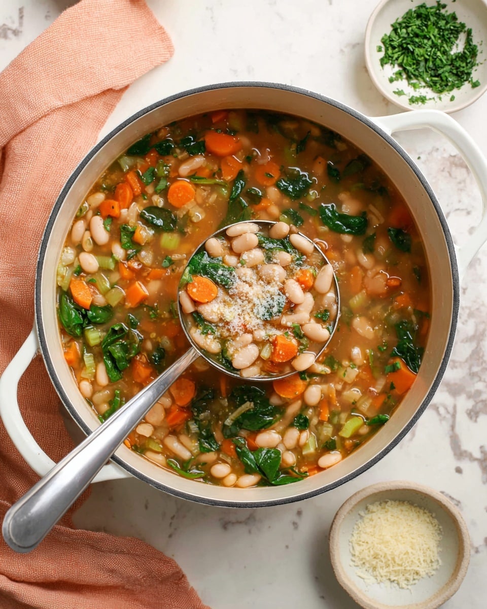 A white pot filled with a colorful vegetable and bean soup showing large white beans, bright orange carrot cubes, green celery pieces, and dark green spinach leaves all floating in a light brown broth. A metal ladle is scooping some soup, displaying these layers clearly, and there is a sprinkle of grated cheese on top. Around the pot are small white bowls with finely chopped green herbs and grated cheese, set on a white marbled surface with a soft peach cloth underneath one handle. photo taken with an iphone --ar 4:5 --v 7