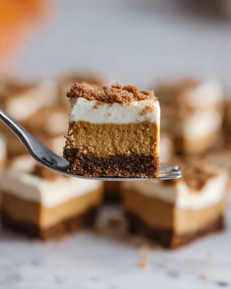 A close-up of a fork holding a small square piece of dessert with three layers: the bottom crust is dark brown and crumbly, the middle layer is light brown and smooth like a soft cake or pumpkin filling, and the top layer is white and creamy with some brown crumbs on top. In the blurry background, you can see more square pieces of the same dessert arranged on a white marbled surface. Photo taken with an iphone --ar 4:5 --v 7