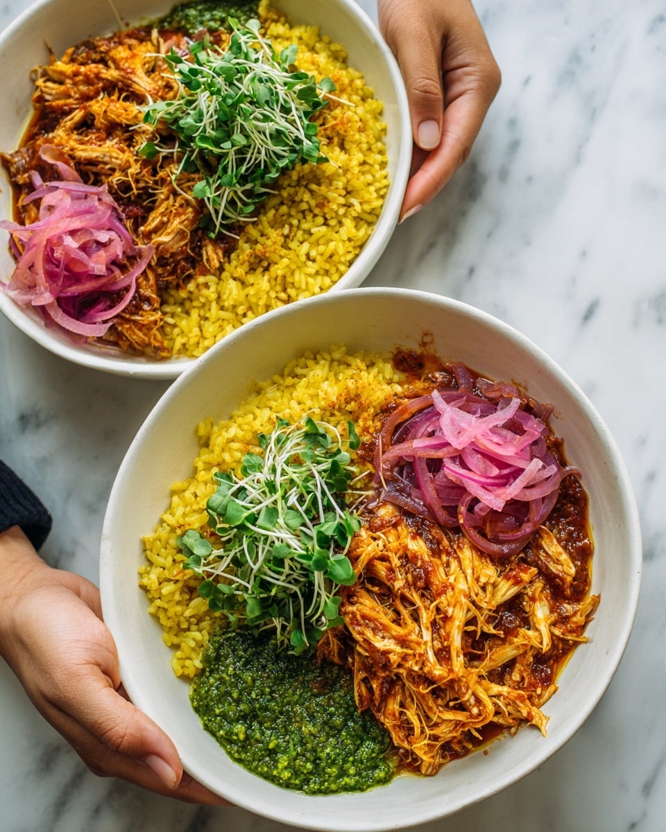 Two white shallow bowls are shown from above, each containing three main sections of food. On one side, there is a heap of yellow rice with a grainy texture. Next to it, there is a portion of shredded chicken in a reddish-brown sauce, with strands loosely piled. Atop the rice and chicken, there is a bright green chunky sauce or pesto. Along one edge of each bowl, thin slices of purple pickled onions rest beside a small bunch of fresh green microgreens with delicate stems. The bowls are held by a woman's hand on the left and by someone's hand on the right, with a white marbled surface visible below. Photo taken with an iphone --ar 4:5 --v 7