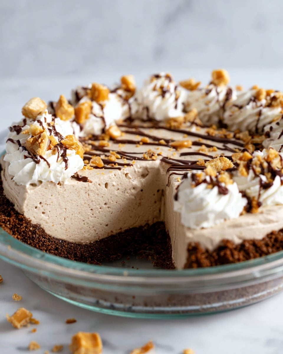 A slice of peanut butter pie with three layers is being lifted by a fork. The bottom layer is a dark crumbly crust, the middle layer is a thick, light brown creamy peanut butter filling, and the top layer is white whipped cream decorated with chopped peanuts and drizzled with chocolate sauce. The pie sits in a clear glass pie dish on a white marbled surface, with crumbs and chopped peanuts scattered around. Photo taken with an iphone --ar 4:5 --v 7