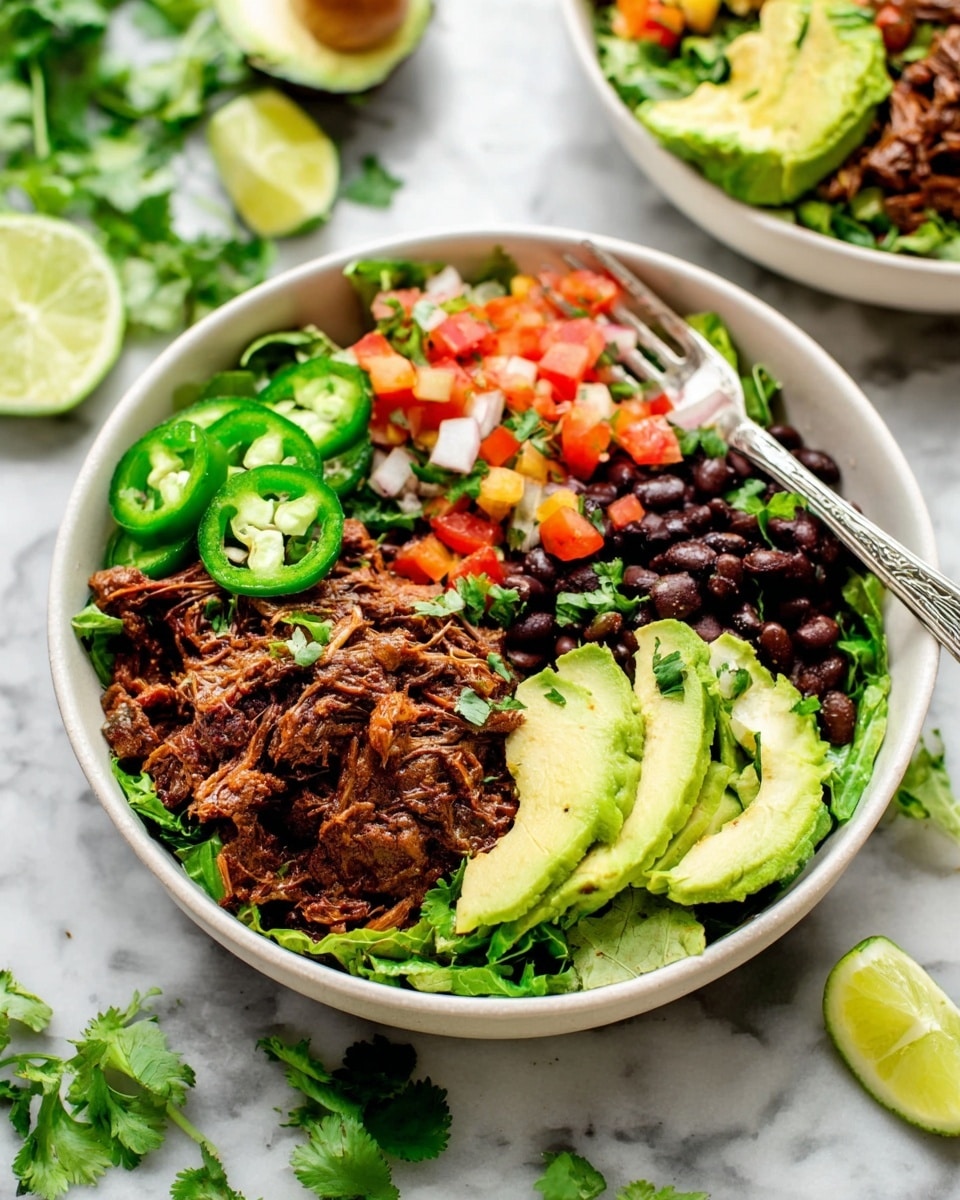 A white bowl contains several colorful layers starting with a bed of chopped green lettuce at the bottom. On the left side, there is a portion of shredded, dark brown meat that looks juicy and spiced. Above the meat, slices of bright green jalapeño peppers are placed. Next to the meat, there is a small pile of black beans mixed with diced red tomatoes. On top of the beans and to the right, there are thin slices of fresh, light green avocado. Scattered over the top are small chunks of diced tomatoes and onions in red, white, and orange colors, along with some green cilantro leaves. A silver fork rests inside the bowl near the meat. The bowl sits on a white marbled surface with lime wedges and green cilantro leaves around it. Photo taken with an iphone --ar 4:5 --v 7