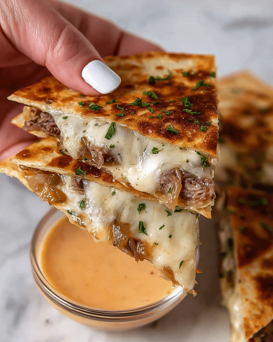 A close-up view shows a triangular quesadilla slice held by a woman's hand with white polished nails. The quesadilla has three visible layers: a golden-brown toasted tortilla on top sprinkled with small green herbs, a middle layer of melted creamy white cheese mixed with caramelized brown onions, and the bottom layer of the tortilla, which is slightly crispy and toasted. Inside, there are bits of tender cooked beef that peek through the melted cheese and onions. The quesadilla is held above a clear glass cup filled with a light orange dipping sauce. The background is a white marbled texture with another quesadilla slice blurred in the back. photo taken with an iphone --ar 4:5 --v 7