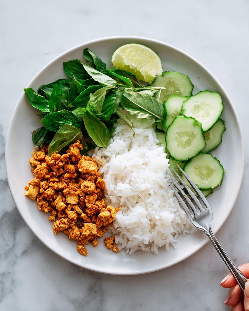 A white round plate is divided into four sections, starting from the left with a layer of golden-brown cooked scrambled tofu with a crumbly texture. Next to it on the upper center are fresh green leafy herbs with a smooth surface, adding a fresh look. The middle center of the plate holds a neat mound of fluffy white rice with visible grains. On the right side, there are light green cucumber slices stacked slightly overlapping with a wedge of lime placed above them, showing a vibrant green outer peel and juicy pale green inside. The plate is set on a white marbled surface with a silver fork placed on the right side, and a woman's hand is about to pick up the fork. photo taken with an iphone --ar 4:5 --v 7