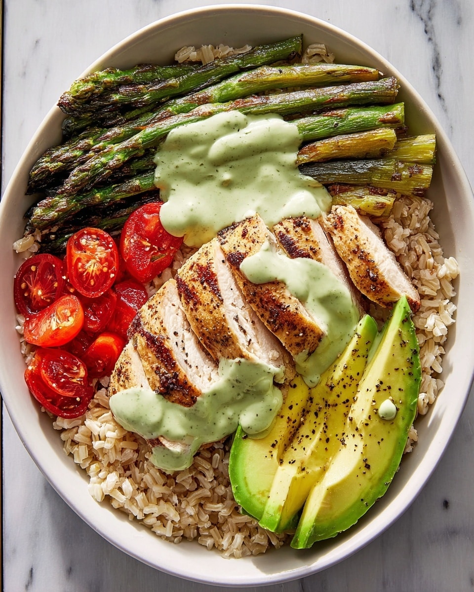A white bowl filled with a base layer of light brown cooked rice. On top of the rice, there are three main layers arranged side by side: grilled green asparagus spears with char marks, sliced red cherry tomatoes, and two thick slices of sliced, grilled chicken breast arranged in a fan shape. On one side, there are two large slices of bright green avocado with black pepper sprinkled on them. A light green creamy sauce is being drizzled over the chicken and asparagus with some also over the avocado and tomatoes. The bowl is placed on a white marbled surface. photo taken with an iphone --ar 4:5 --v 7