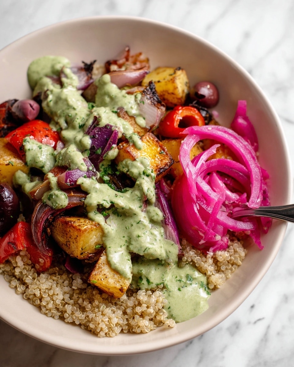 A white bowl holds a colorful dish with three main layers: at the bottom is a bed of light beige quinoa, above it are roasted vegetable chunks including golden-brown potatoes, red bell peppers, and purple onions with a slightly charred texture, and to the side are dark purple olives and bright pink pickled onions coiled in strips. The entire dish is drizzled generously with a creamy green herb sauce that looks smooth and fresh, lightly covering the vegetables. The bowl sits on a white marbled textured surface, and a silver spoon is partially visible resting in the bowl. photo taken with an iphone --ar 4:5 --v 7