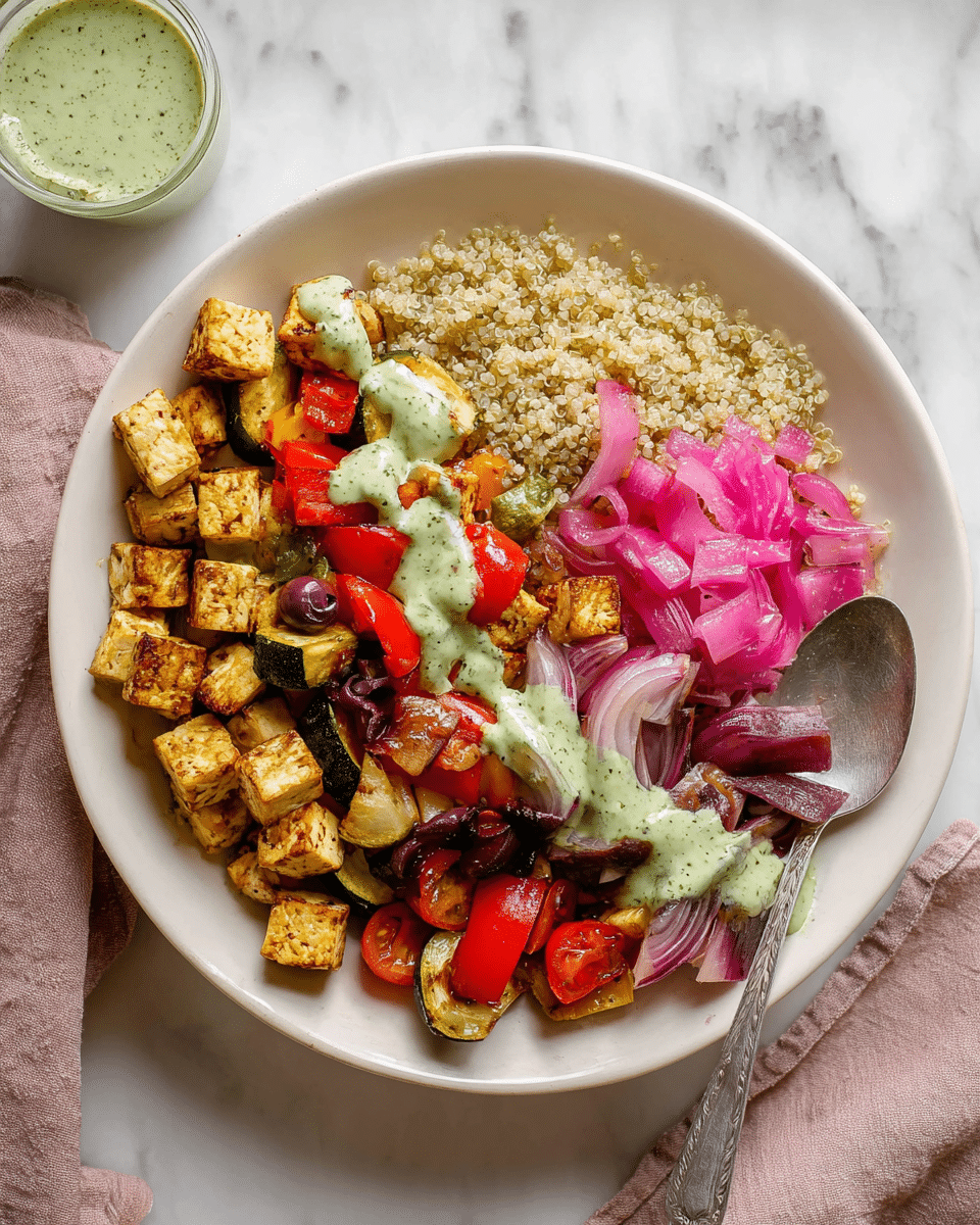 A white plate holds a colorful vegetarian dish with four main parts: on the left, small golden-brown grilled tofu cubes; next to tofu, light beige quinoa grains; in the middle, a mix of roasted vegetables including red bell peppers, zucchini, cherry tomatoes, and red onion pieces with a soft grilled texture; on the right, bright pink pickled onions topped with dark purple olives. All layers are lightly drizzled with a creamy green herb sauce that adds a fresh touch. A silver spoon rests on the right edge of the plate, and the background is a white marbled surface. photo taken with an iphone --ar 4:5 --v 7