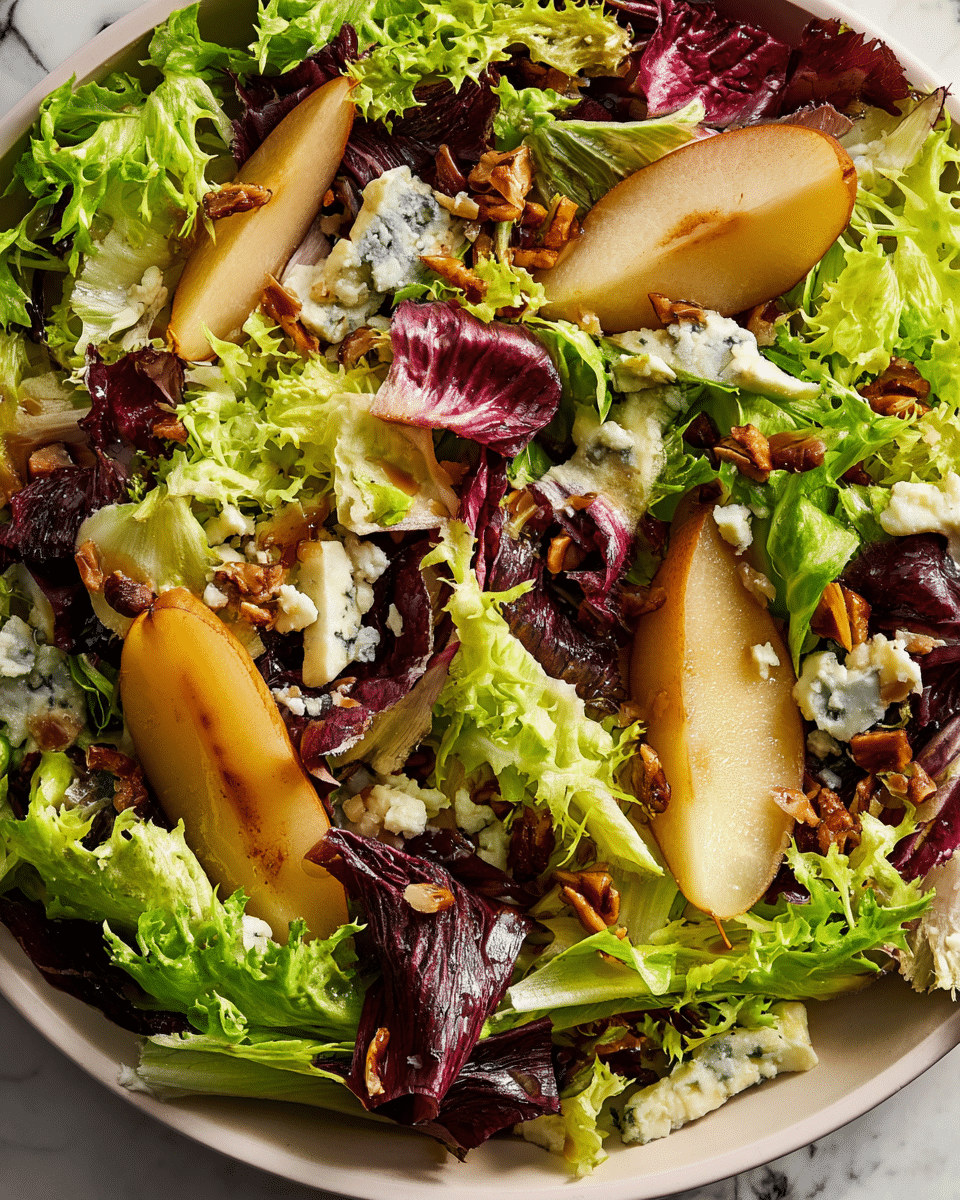 The image shows a close-up of a fresh salad with several layers. The bottom layer is a mix of green curly lettuce and purple radicchio leaves with a crunchy texture. On top, there are slices of golden-brown cooked pears with a soft and juicy look. Scattered around are small pieces of white and blue veined cheese, adding a creamy feel. Also sprinkled are toasted brown nuts or seeds, which add texture and a bit of shine. The whole salad sits on a white plate placed on a white marbled surface. photo taken with an iphone --ar 4:5 --v 7
