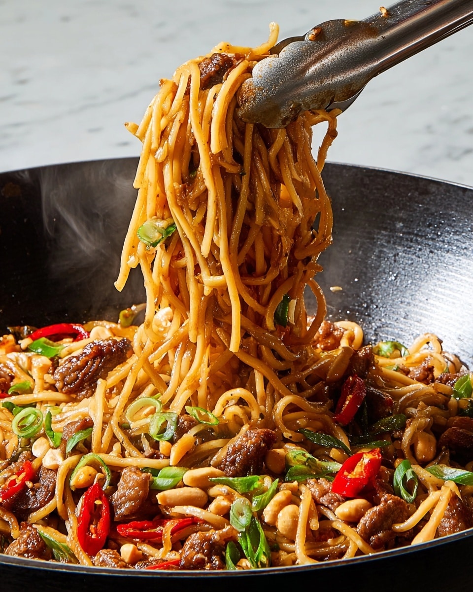 A close-up of stir-fried noodles lifted by metal tongs from a black wok on a white marbled surface, showing three main layers: glossy brown noodles coated in sauce with a soft, slippery texture; scattered pieces of tender brown meat and bright red chili slices, adding chewiness and spice; and chopped green onions and peanuts, giving fresh green color and crunchy texture, all mixed together and steaming slightly, highlighting the dish's warmth and mix of flavors. photo taken with an iphone --ar 4:5 --v 7