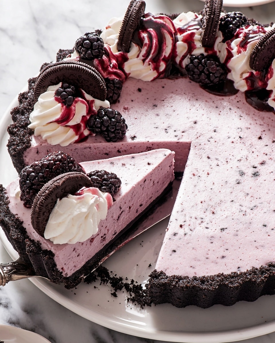 This dish shows a three-layer tart on a white plate with a white marbled surface beneath. The bottom layer is a dark, crumbly chocolate crust forming a thick base with a scalloped edge. The middle layer is a smooth, thick pale purple filling with fine speckles, cut into slices. The top layer consists of whipped cream swirled with dark red berry sauce, decorated with fresh blackberries and mini chocolate sandwich cookies placed unevenly along the edge. One slice is slightly lifted on a pie server, showing the clean cut edges of all layers clearly. Photo taken with an iphone --ar 4:5 --v 7