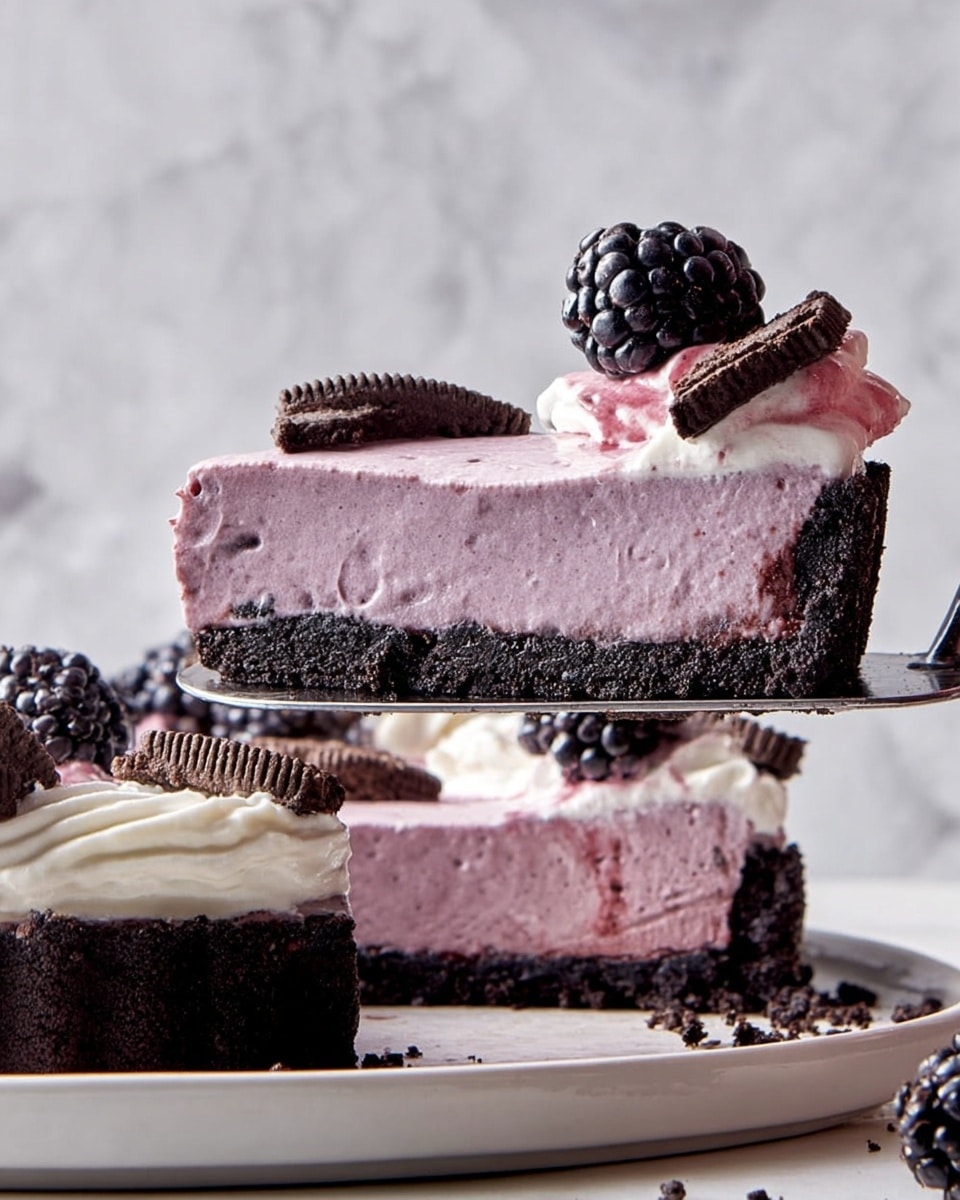 A slice of a three-layer tart is being lifted by a spatula, showing a bottom dark chocolate crust with a crumbly texture, a thick middle layer of smooth light purple mousse, and a top layer of off-white whipped cream with hints of purple swirls. On top of the whipped cream, there is a fresh black blackberry and a small piece of chocolate sandwich cookie. The rest of the tart on a white plate is visible below, with similar decorations of blackberries, whipped cream, and cookie pieces. The background has a white marbled texture. Photo taken with an iphone --ar 4:5 --v 7