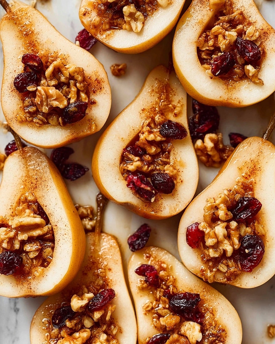 The image shows sliced pears, each cut in half and placed on a white marbled surface, with about a dozen halves visible. Each pear half has a hollow center filled with a mixture of granola, walnuts, and dried cranberries that add texture and color contrast. The pear skin is light brown with a smooth texture while the flesh is pale cream. A light dusting of cinnamon powder covers the pear halves, giving a warm, slightly reddish-brown tint. The nuts and dried fruit filling appear chunky and crumbly with specks of glossy syrup adding shine. The pears are arranged close together, some overlapping slightly, creating a warm and inviting display. Photo taken with an iphone --ar 4:5 --v 7